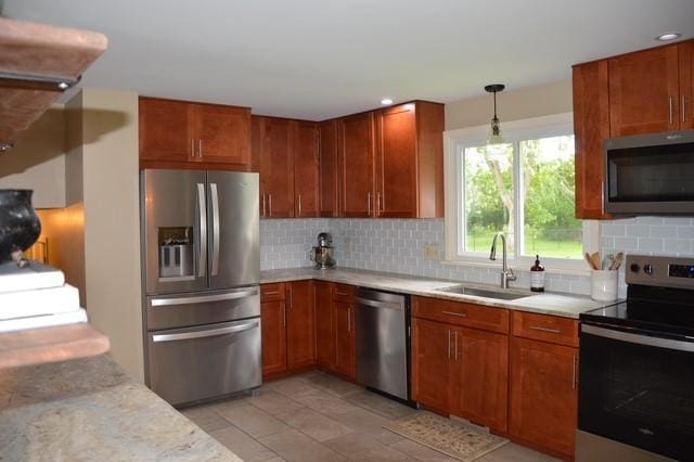 57 Timberline Dr, Penfield, NY 14526 - kitchen featuring appliances with stainless steel finishes, backsplash, brown cabinets, hanging light fixtures, and recessed lighting