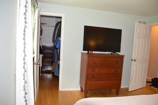 57 Timberline Dr, Penfield, NY 14526 - bedroom featuring a spacious closet, wood finished floors, and a closet