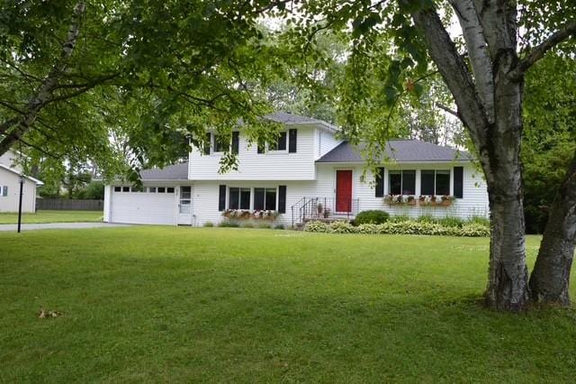 57 Timberline Dr, Penfield, NY 14526 - tri-level home with an attached garage, a front lawn, and driveway