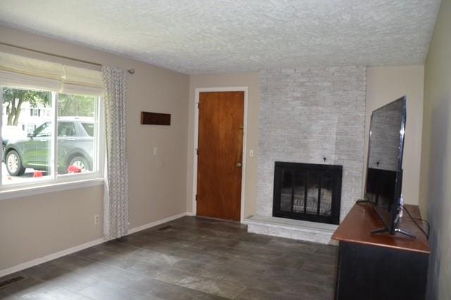 57 Timberline Dr, Penfield, NY 14526 - unfurnished living room featuring a fireplace and a textured ceiling
