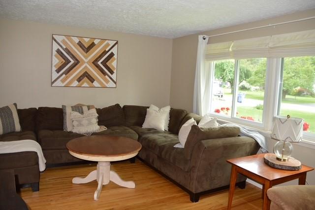 57 Timberline Dr, Penfield, NY 14526 - living room featuring light wood finished floors, a textured ceiling, and plenty of natural light