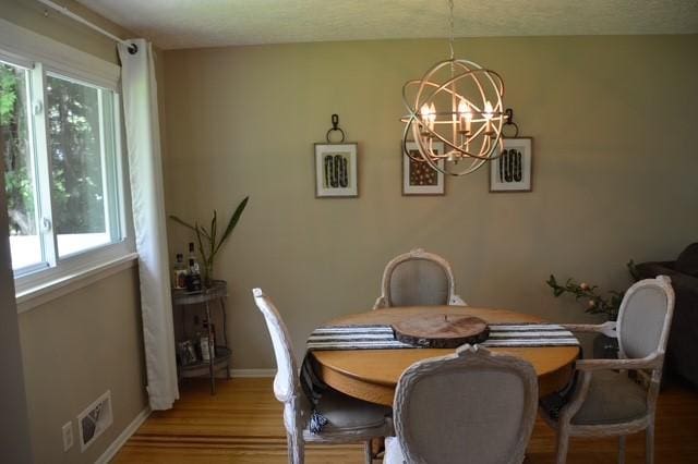 57 Timberline Dr, Penfield, NY 14526 - dining area with healthy amount of natural light, a chandelier, and wood finished floors