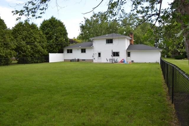 57 Timberline Dr, Penfield, NY 14526 - rear view of house with a fenced backyard and a chimney