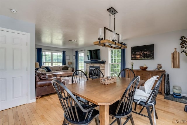 33039 County Route 22, Antwerp, NY 13691 - dining area with a stone fireplace and light wood-style flooring