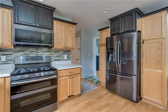 33039 County Route 22, Antwerp, NY 13691 - kitchen with appliances with stainless steel finishes, light wood-type flooring, light countertops, and backsplash