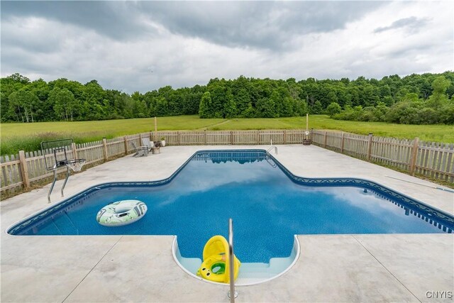 33039 County Route 22, Antwerp, NY 13691 - view of swimming pool featuring a patio, a fenced backyard, and a wooded view