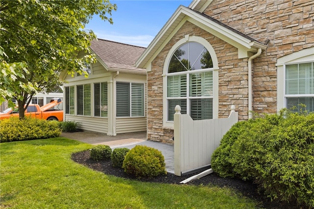 189 Maryview Dr, Penfield, NY 14580 - property entrance featuring stone siding, roof with shingles, and a yard