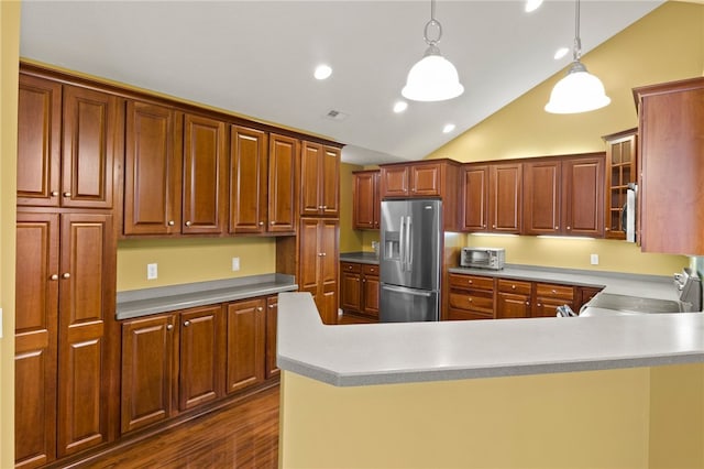 189 Maryview Dr, Penfield, NY 14580 - kitchen with stainless steel appliances, vaulted ceiling, a peninsula, dark wood-style flooring, and hanging light fixtures