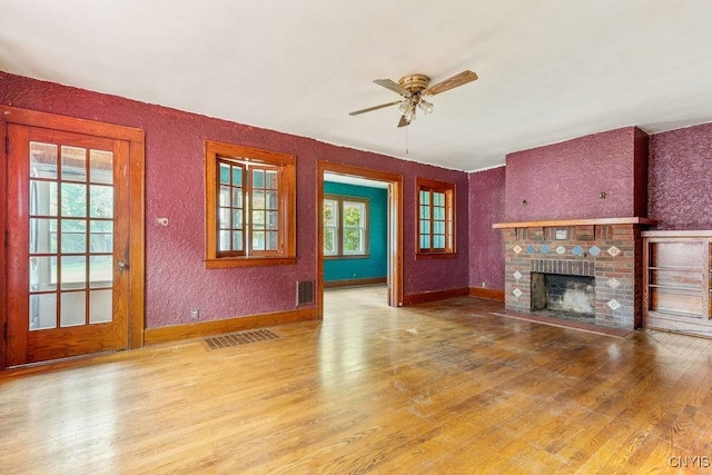 218-20 Avery Ave, Syracuse, NY 13204 - unfurnished living room featuring wood finished floors, ceiling fan, and a fireplace