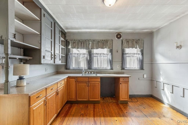 218-20 Avery Ave, Syracuse, NY 13204 - kitchen with open shelves, hardwood / wood-style floors, brown cabinetry, and light countertops