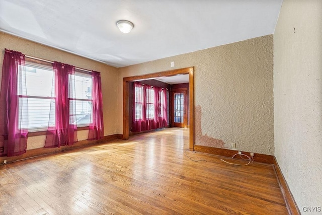 218-20 Avery Ave, Syracuse, NY 13204 - spare room featuring a textured wall and wood finished floors