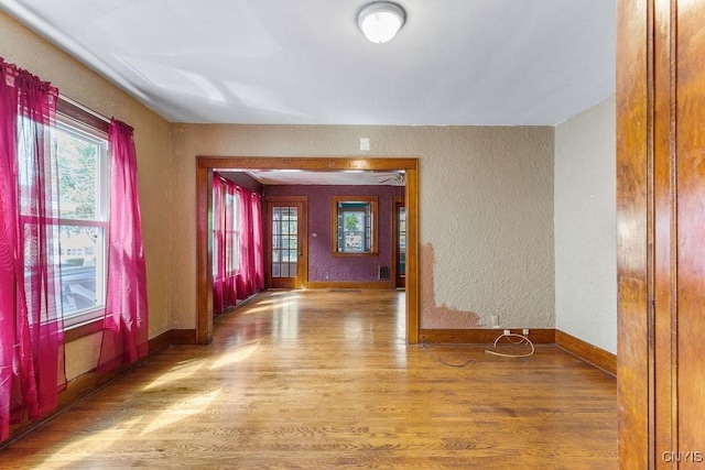 218-20 Avery Ave, Syracuse, NY 13204 - spare room featuring wood finished floors, healthy amount of natural light, and a textured wall