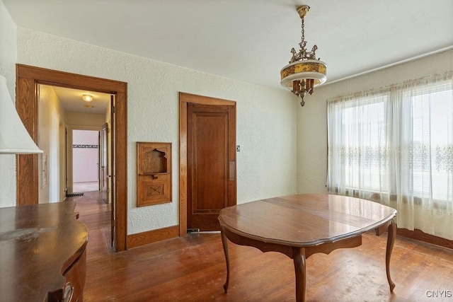 218-20 Avery Ave, Syracuse, NY 13204 - dining area with a textured wall and dark wood-style floors