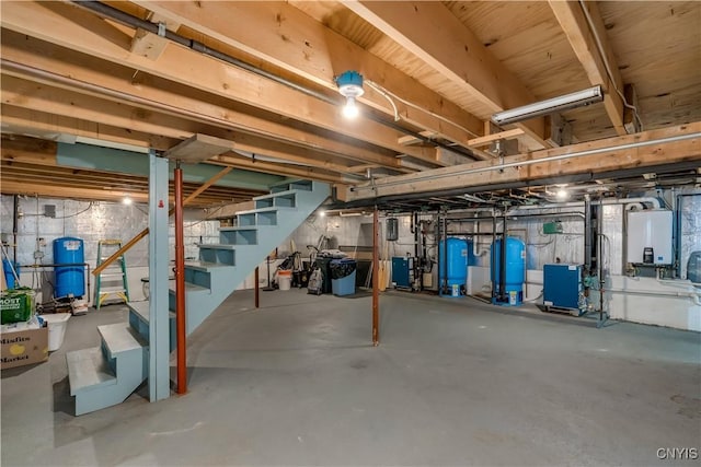 8782 Buck Point Rd, Watson, NY 13367 - unfinished below grade area with a water pressure tank, stairs, and tankless water heater