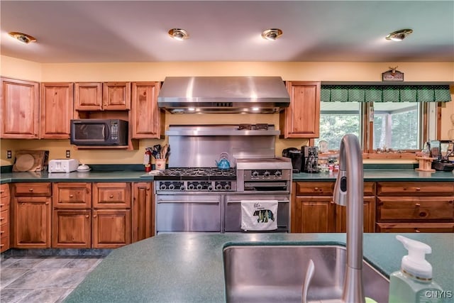 8782 Buck Point Rd, Watson, NY 13367 - kitchen with wall chimney range hood, black microwave, double oven range, dark countertops, and brown cabinets