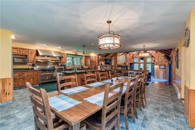 8782 Buck Point Rd, Watson, NY 13367 - dining space with wood walls and a chandelier