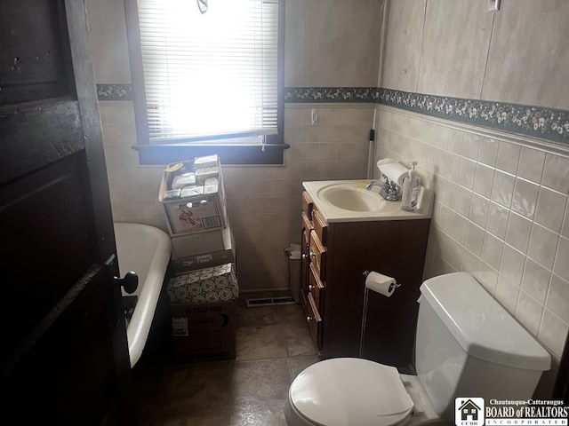 157 W Main St, Allegany, NY 14706 - full bath featuring vanity, tile walls, a tub, and wainscoting