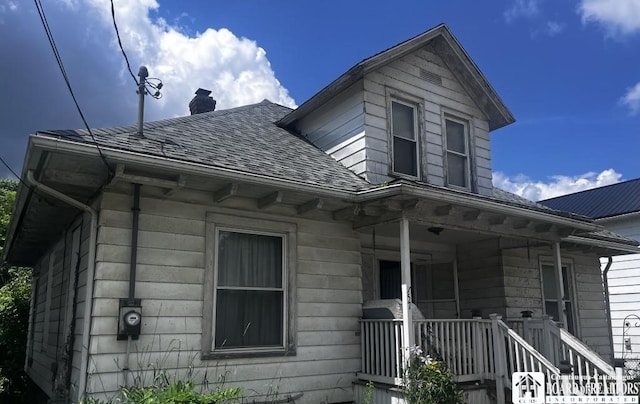 157 W Main St, Allegany, NY 14706 - view of side of home with a shingled roof, a chimney, and covered porch