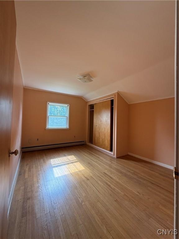 5877 State Route 233, Westmoreland, NY 13440 - bonus room featuring a baseboard heating unit, wood-type flooring, and vaulted ceiling