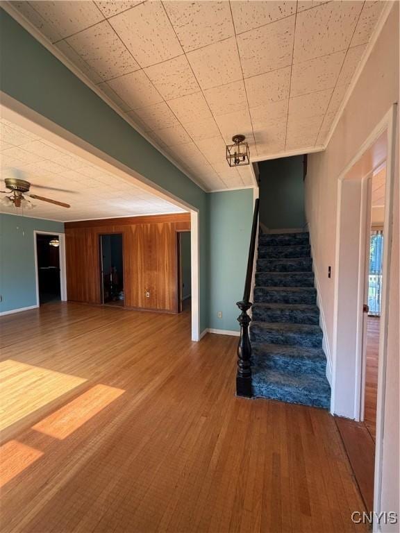 5877 State Route 233, Westmoreland, NY 13440 - unfurnished living room with wood finished floors, stairs, a ceiling fan, and crown molding