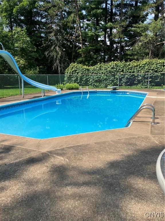 5877 State Route 233, Westmoreland, NY 13440 - view of swimming pool with a water slide, a diving board, view of wooded area, and a patio area