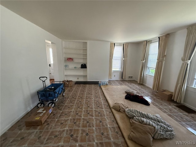 75 Main St, North Dansville, NY 14437 - unfurnished living room with built in shelves and baseboards