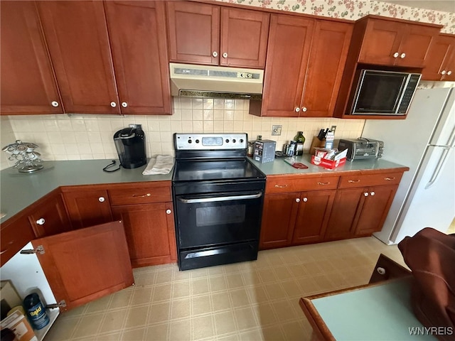 75 Main St, North Dansville, NY 14437 - kitchen featuring black range with electric stovetop, under cabinet range hood, freestanding refrigerator, and light floors
