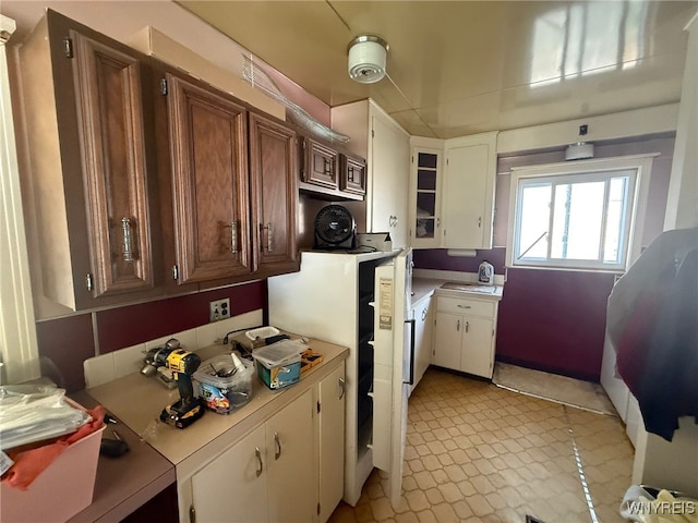 75 Main St, North Dansville, NY 14437 - kitchen featuring light countertops, white cabinets, and brown cabinets