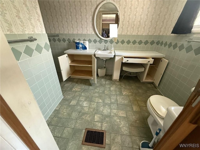 75 Main St, North Dansville, NY 14437 - half bath featuring wallpapered walls, tile walls, and wainscoting