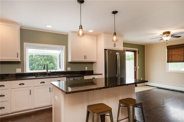 1192 Clendenning Rd, Lindley, NY 14870 - kitchen with appliances with stainless steel finishes, a kitchen breakfast bar, ornamental molding, pendant lighting, and a kitchen island