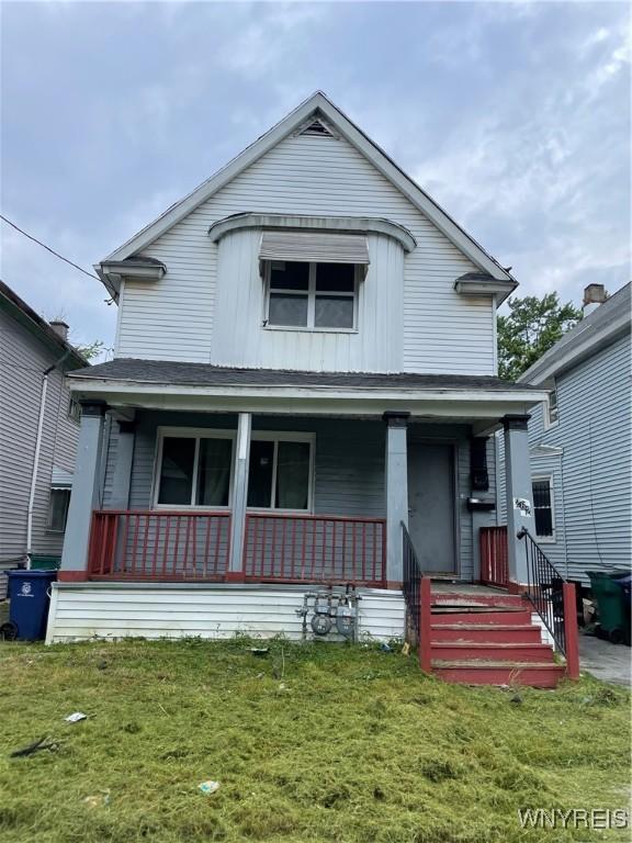 262 Sumner Pl, Buffalo, NY 14211 - view of front of home with a porch, a front yard, and board and batten siding