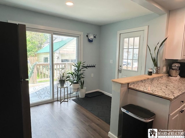12 Juliet St, Jamestown, NY 14701 - kitchen featuring freestanding refrigerator, dark wood-style floors, recessed lighting, and white cabinets