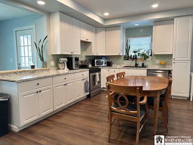 12 Juliet St, Jamestown, NY 14701 - kitchen featuring appliances with stainless steel finishes, white cabinets, plenty of natural light, and recessed lighting