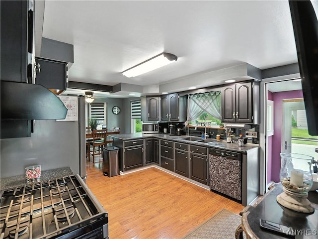 5137 William St, Lancaster, NY 14086 - kitchen with appliances with stainless steel finishes, dark countertops, light wood-style flooring, and a peninsula