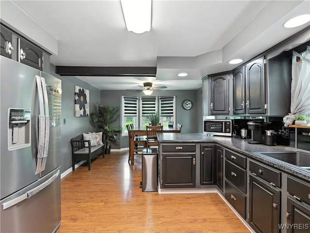 5137 William St, Lancaster, NY 14086 - kitchen with stainless steel appliances, ceiling fan, dark countertops, a peninsula, and light wood-style flooring