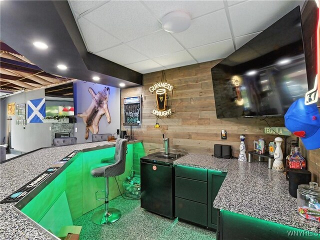 5137 William St, Lancaster, NY 14086 - bar area with wooden walls, a drop ceiling, and refrigerator