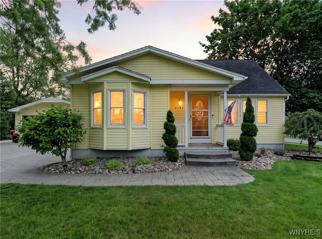 5137 William St, Lancaster, NY 14086 - bungalow-style house with a front lawn and driveway