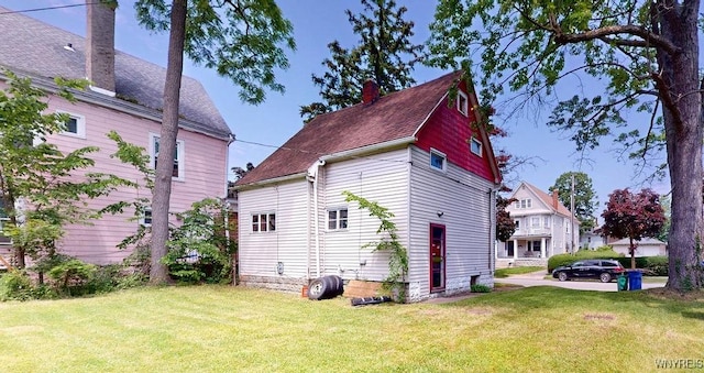 173 Hedley Pl, Buffalo, NY 14208 - view of property exterior with a yard, a chimney, and a shingled roof