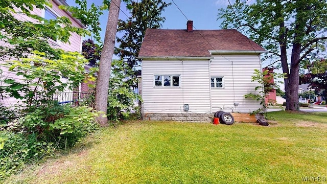 173 Hedley Pl, Buffalo, NY 14208 - back of house with a lawn, a chimney, and a shingled roof