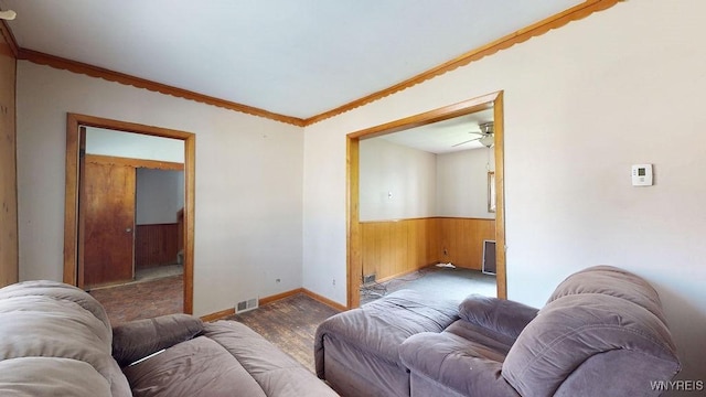 173 Hedley Pl, Buffalo, NY 14208 - living area with wooden walls, wood finished floors, a wainscoted wall, ceiling fan, and crown molding