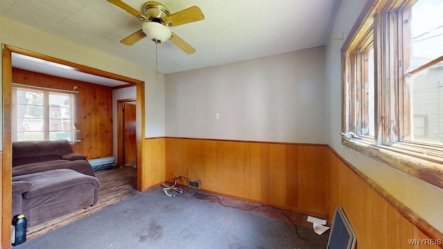 173 Hedley Pl, Buffalo, NY 14208 - unfurnished room with wood walls, wainscoting, a ceiling fan, and carpet floors