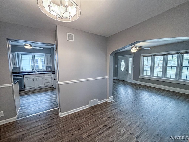 221 82nd St, Niagara Falls, NY 14304 - unfurnished dining area with a ceiling fan, arched walkways, dark wood-style flooring, and a chandelier