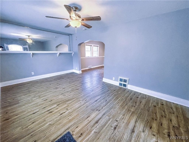 221 82nd St, Niagara Falls, NY 14304 - unfurnished living room featuring arched walkways, ceiling fan, and wood finished floors