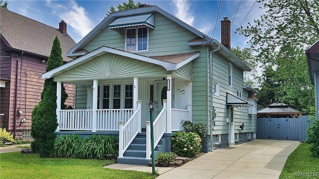 221 82nd St, Niagara Falls, NY 14304 - view of front of home with covered porch, a chimney, and a front lawn