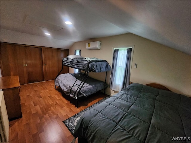 2207 Sheldon Dr, Allegany, NY 14706 - bedroom with vaulted ceiling, light wood finished floors, attic access, a wall mounted AC, and recessed lighting
