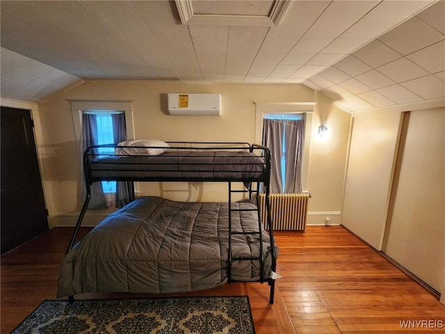 2207 Sheldon Dr, Allegany, NY 14706 - bedroom featuring a wall mounted AC, lofted ceiling, wood finished floors, and multiple windows