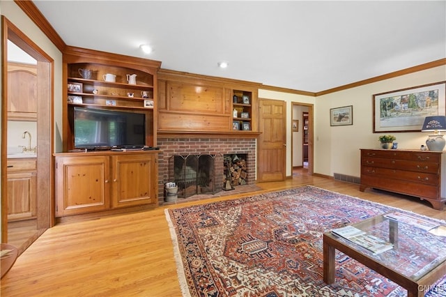 8074 Irish Mist Ln, Manlius, NY 13104 - living area featuring light wood finished floors, a brick fireplace, and ornamental molding