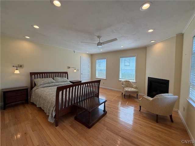 320 W 3rd St, Oswego-City, NY 13126 - bedroom featuring recessed lighting, light wood finished floors, a glass covered fireplace, a ceiling fan, and crown molding