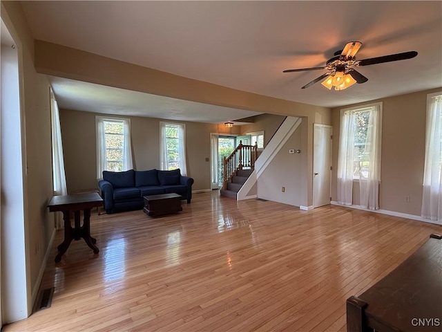 320 W 3rd St, Oswego-City, NY 13126 - living area with stairway, light wood-style flooring, and a ceiling fan