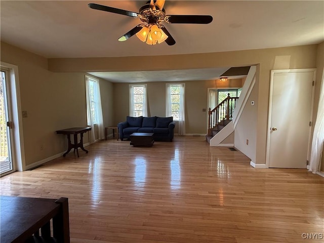 320 W 3rd St, Oswego-City, NY 13126 - living area with light wood-type flooring, stairs, and ceiling fan
